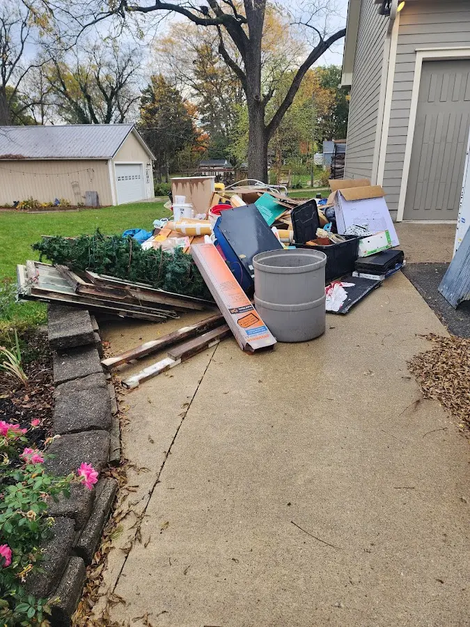 Dumpster being loaded with debris for 12 Yard Dumpster Rental in Nowata